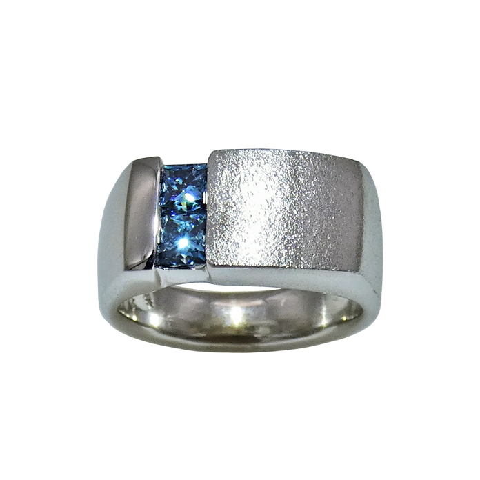 Channel Set Men's Ring Item# CCJ-KRW-BD-1220 Designer: Grace Koorey Stone: Two princess cut color-enhanced blue diamonds = 1.0ct Setting: 14KWG = 12dwt